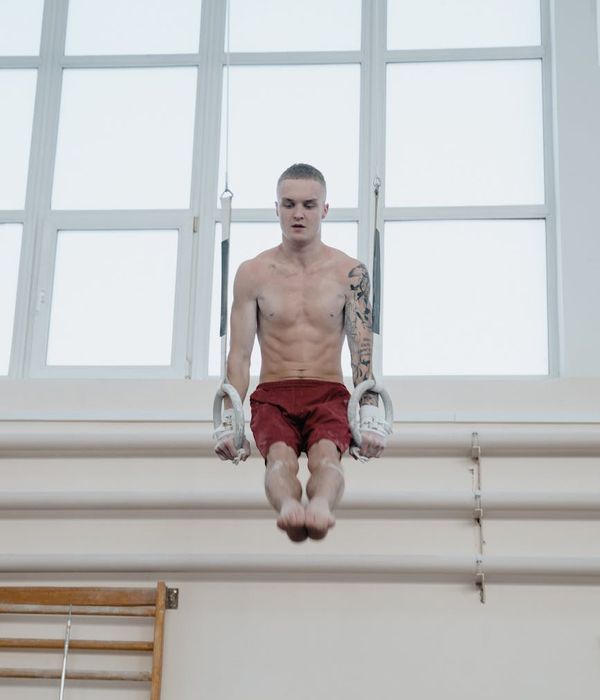 Man performing a strength and balance exercise in a calm environment.